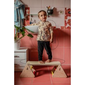 A child stands on the multifunctional balance trainer in the bathroom