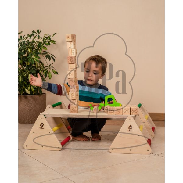A child playing with blocks on a balance constructor