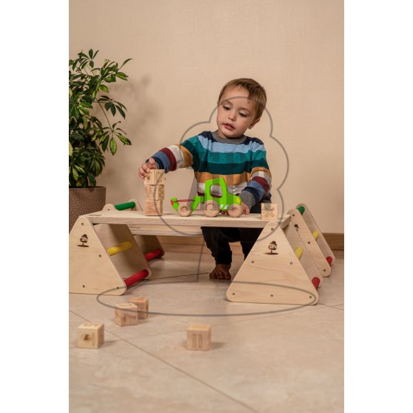 A child playing with alphabet blocks on a balance constructor