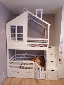 White bunk bed with safety gate.