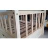 Round, lacquered slats, close-up view. Lacquered bunk bed for children with play area under the upper floor.