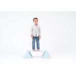 Balance constructor, blue. The boy is standing on the balance constructor, the board is placed at the highest level, straight.